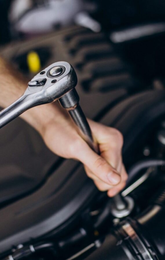 repair-man-making-car-service-scaled-psg88a95dtb1mkopc0qqyqf110gkgsgre8zbyslki8